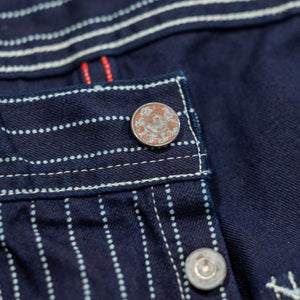 Navy striped fatigue pocket pants close up on rtop button laying flat