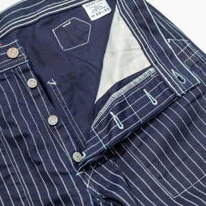 Navy striped fatigue pocket pants close up on open fly and thigh with solid navy interior laying flat