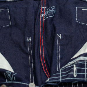 Navy striped fatigue pocket pants close up on solid navy interior and red internal stitching laying flat