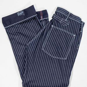 Navy striped fatigue pocket pants folded with hem cuffed to show solid navy interior and Sugar Cane branding, laying flat