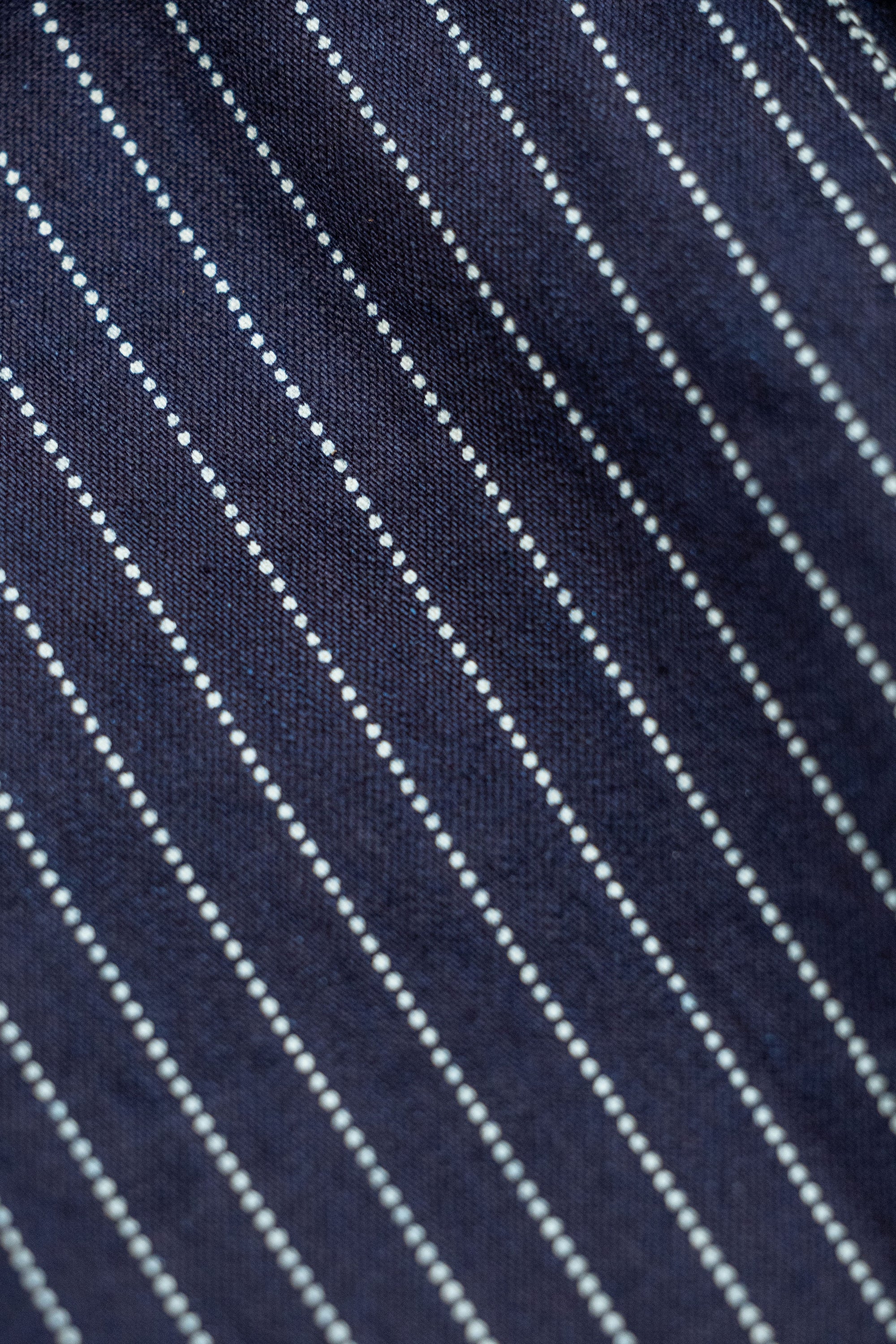 Navy striped fatigue pocket pants close up on fabric