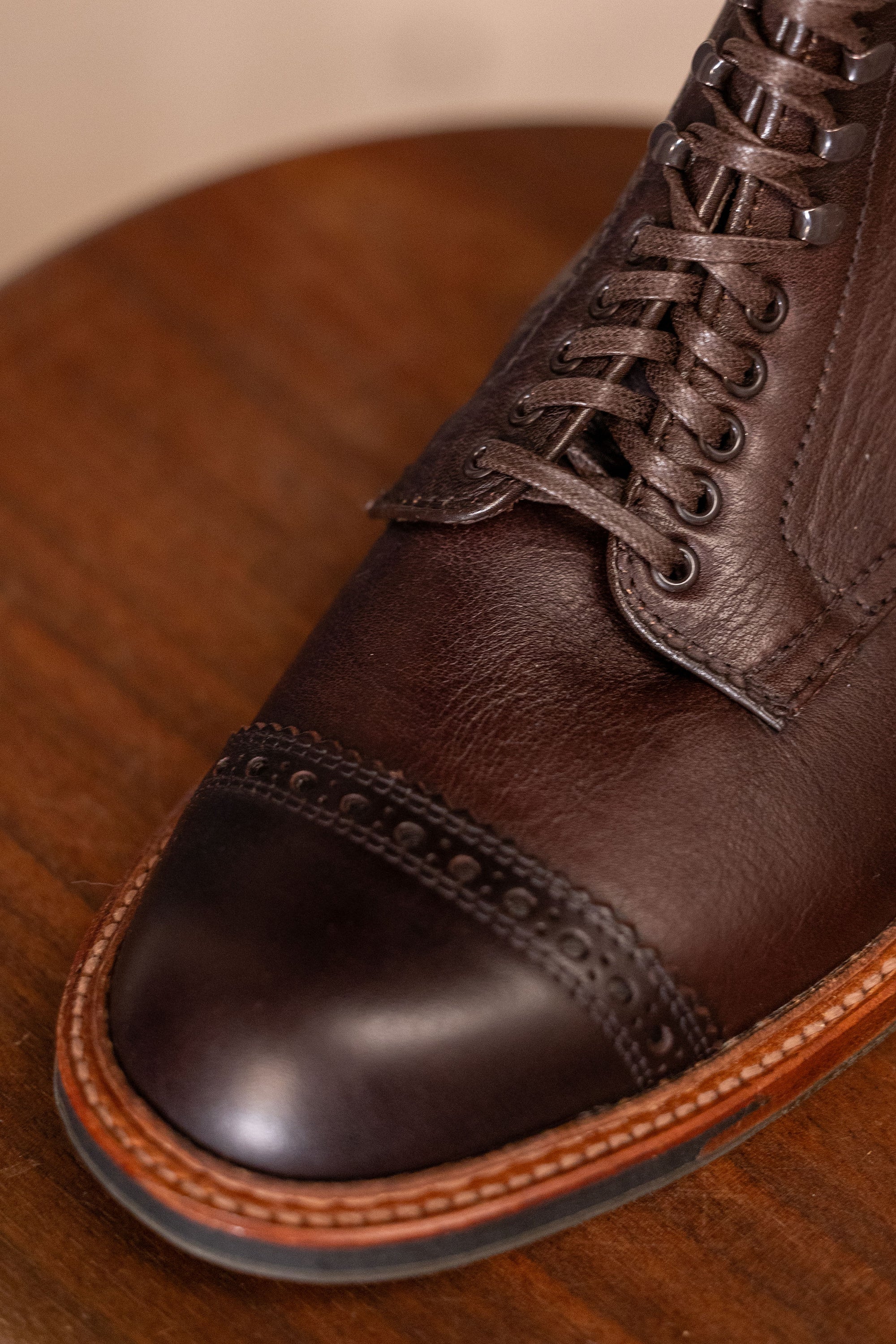 Brown leather cap toe boots close up on toe