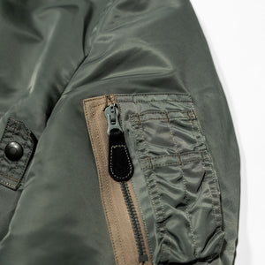 Buzz Rickson's BR14920 Type MA-1 Jacket in Green - Laying flat, close up on sleeve pocket