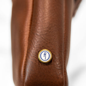 Bleu de Chauffe Folder Business Bag - Amber Brown. detail shot of side emblem 