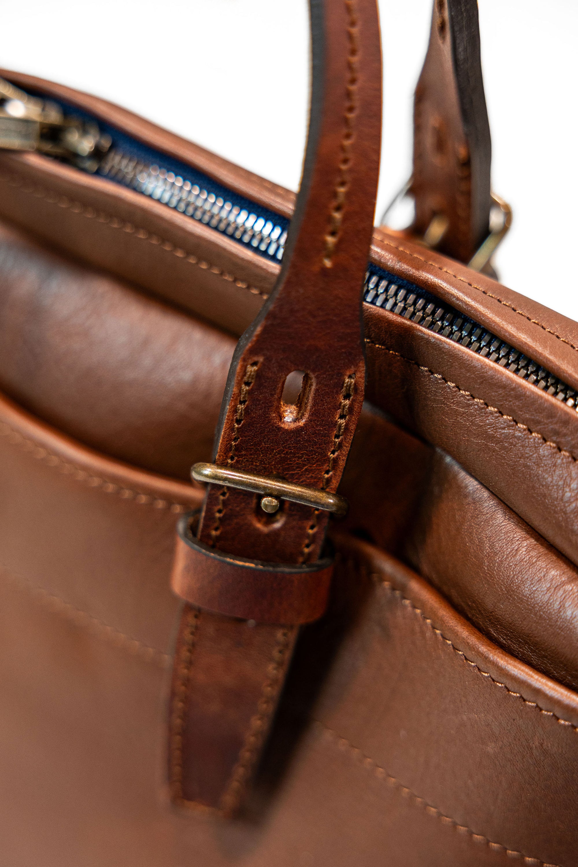 Bleu de Chauffe Folder Business Bag - Amber Brown. detail shot of attached bag strap