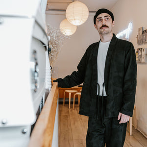 Hansen Garments Roman Loose Cut Jacket - Black Flowers - model shot - front facing - cafe background