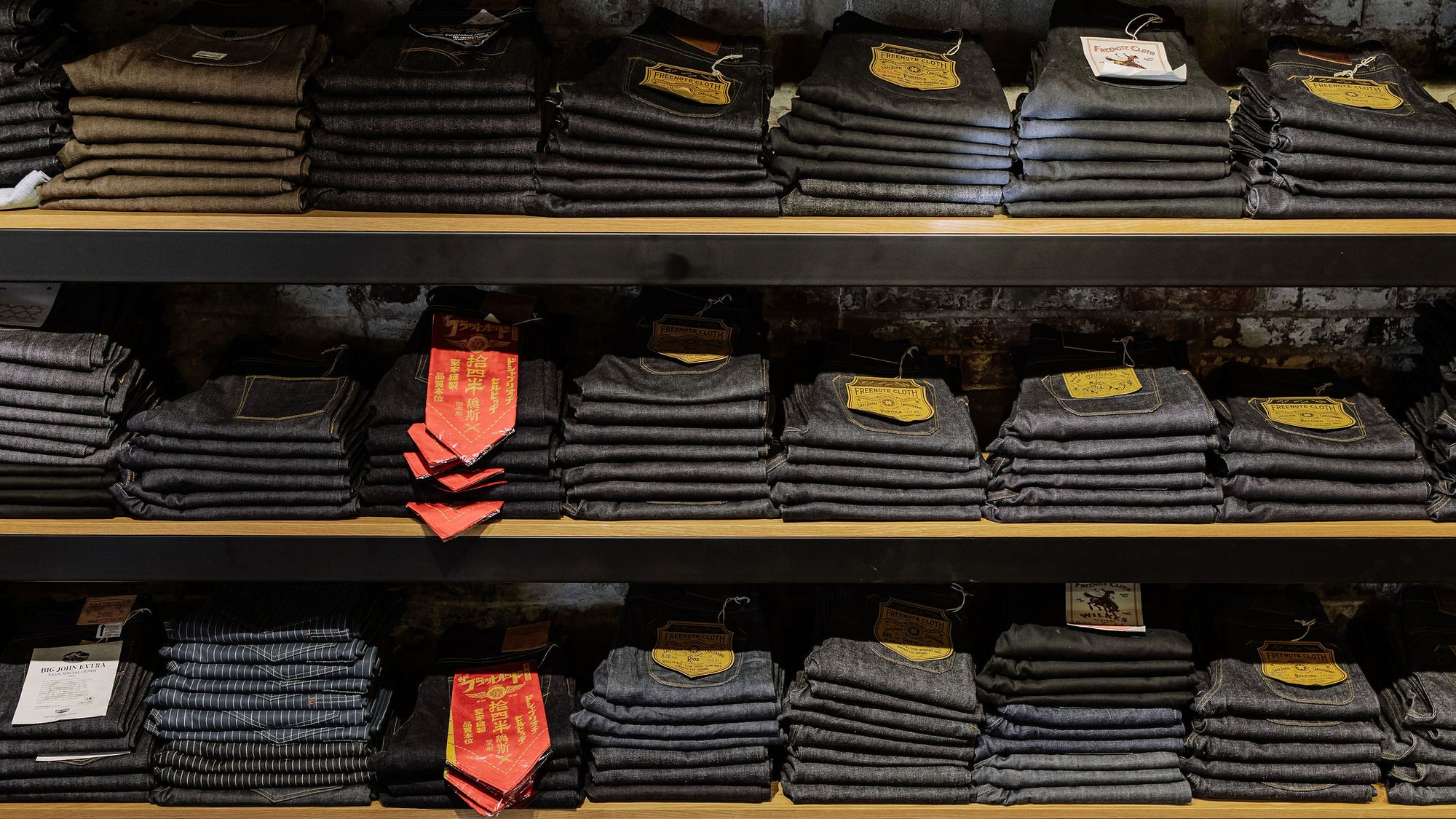 The denim wall at Franklin and Poe featuring stacks of folded denim