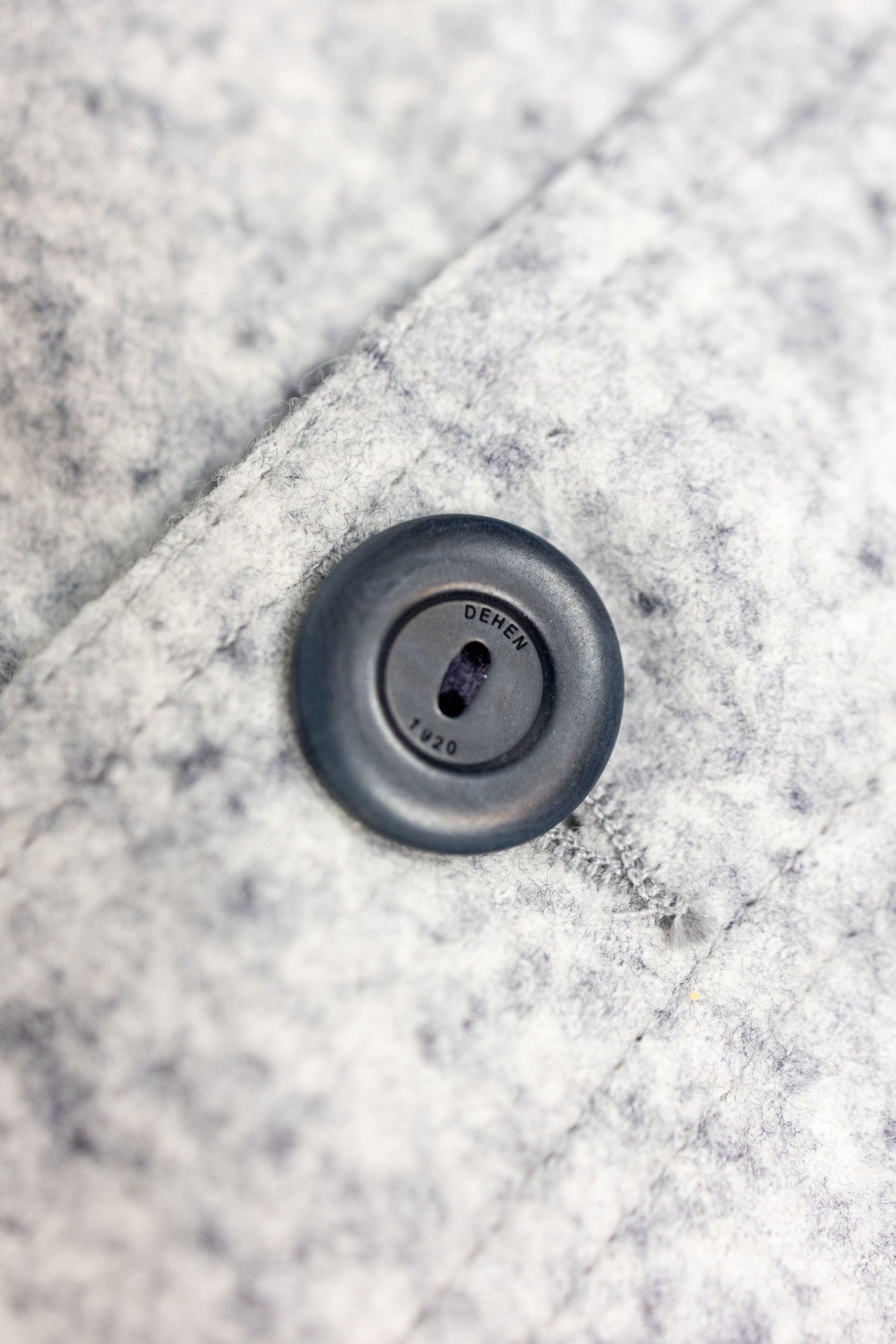 Dehen 1920 Chore Coat - Natural & Navy Heather Wool. close up shot of button branding