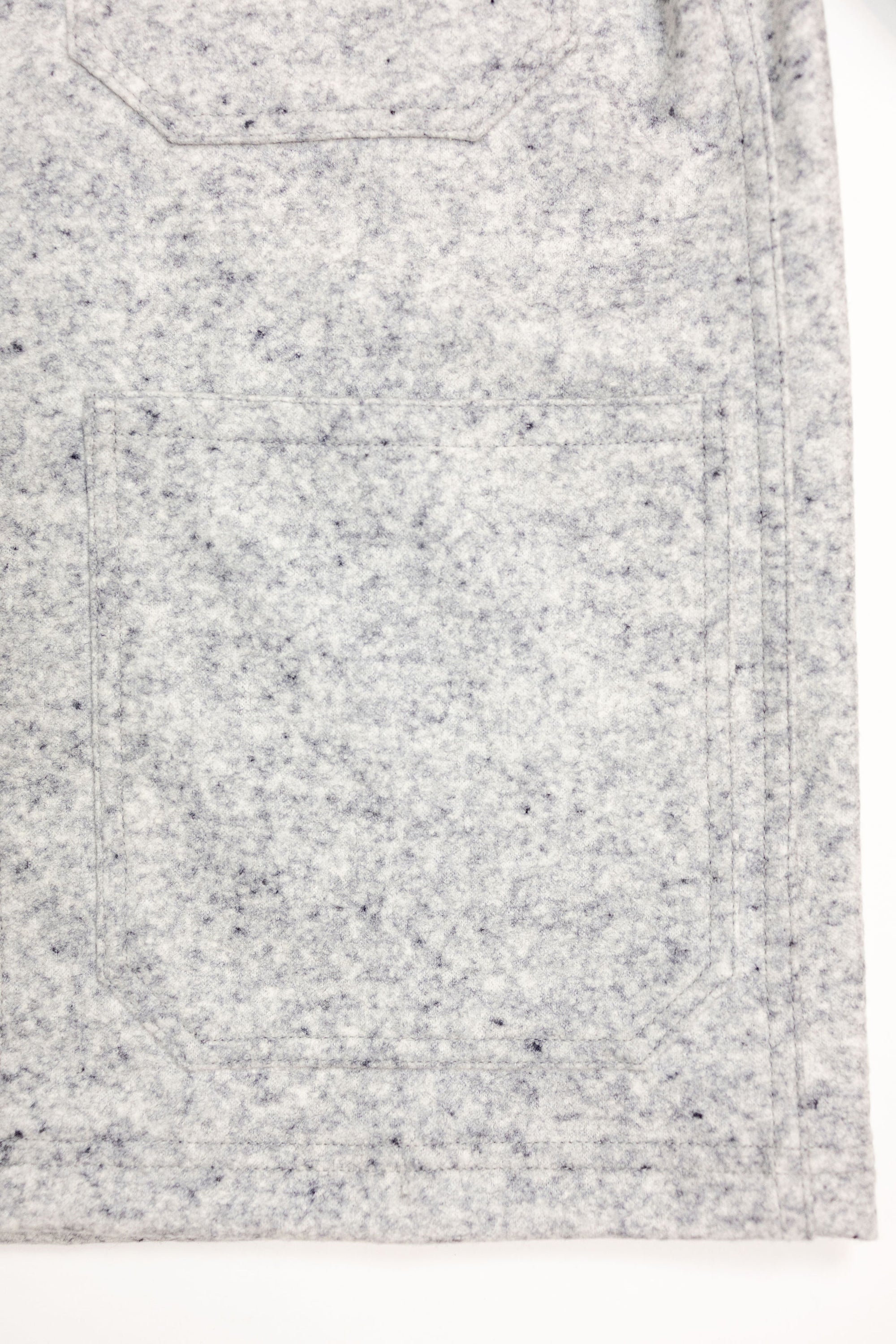 Dehen 1920 Chore Coat - Natural & Navy Heather Wool. close up of bottom pocket