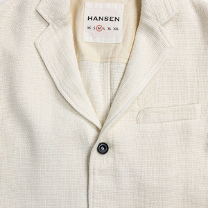 Hansen Garments Charlie Three Button Blazer - Off White Gauze - product shot - close up detail of tag, closed jacket,  and buttons - white background