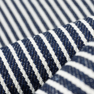 Western style shirt with indigo and white thin vertical stripes close-up on fabric