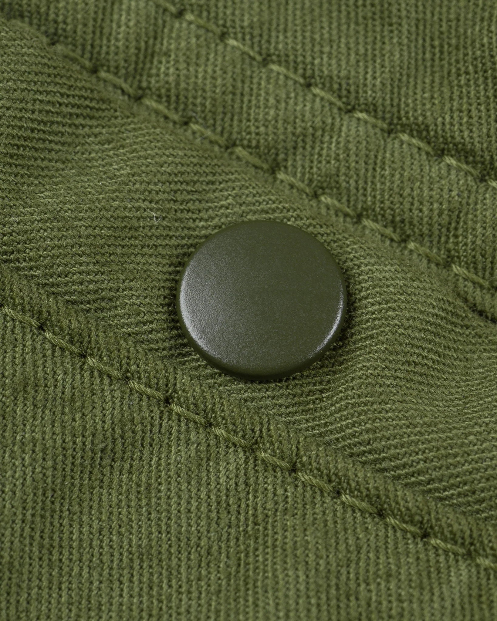 Olive mid length shorts back view laying flat closeup on snap pocket
