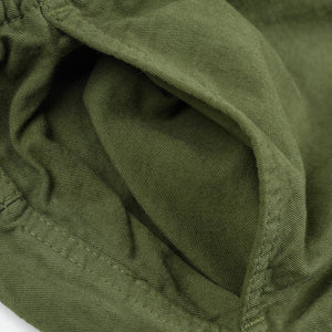 Olive mid length shorts laying flat closeup on side pocket