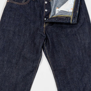 Indigo denim jeans wide cut front view laying flat with fly open