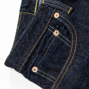Indigo denim jeans wide cut front view laying flat closeup on front pocket