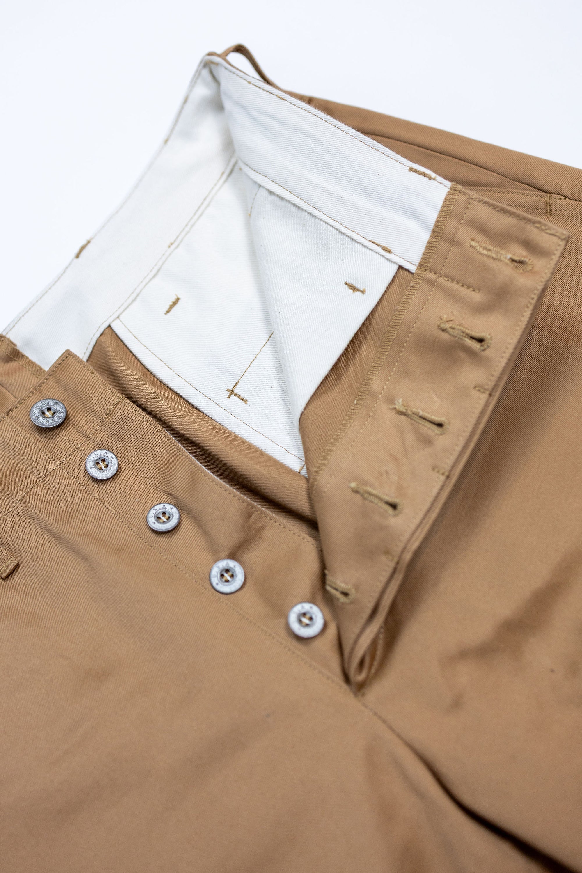 Buzz Rickson's M43035 Early Military Chinos 1945 Model in Camel - Laying flat, close-up on buttons and inner waistband