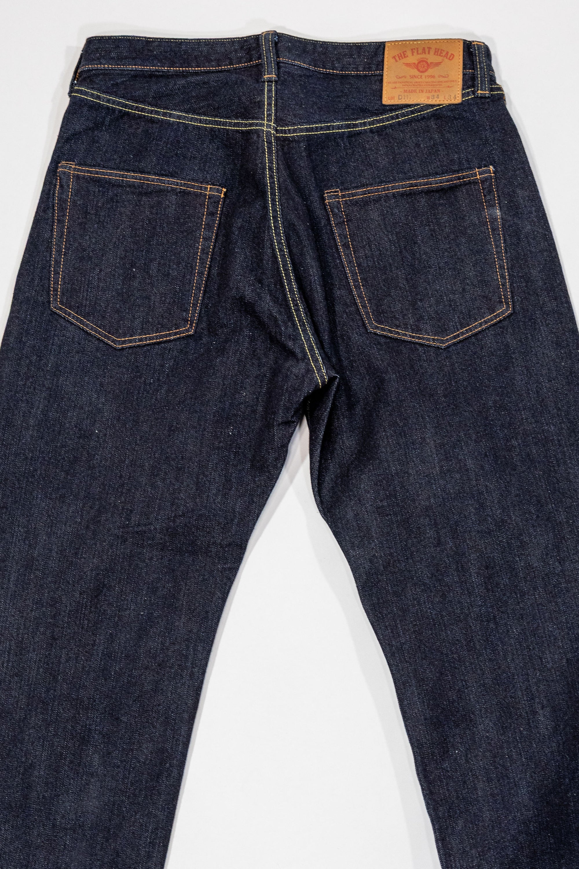 Indigo denim jeans wide cut back view laying flat