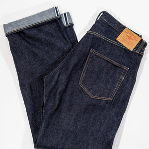 Indigo denim jeans wide cut folded laying flat