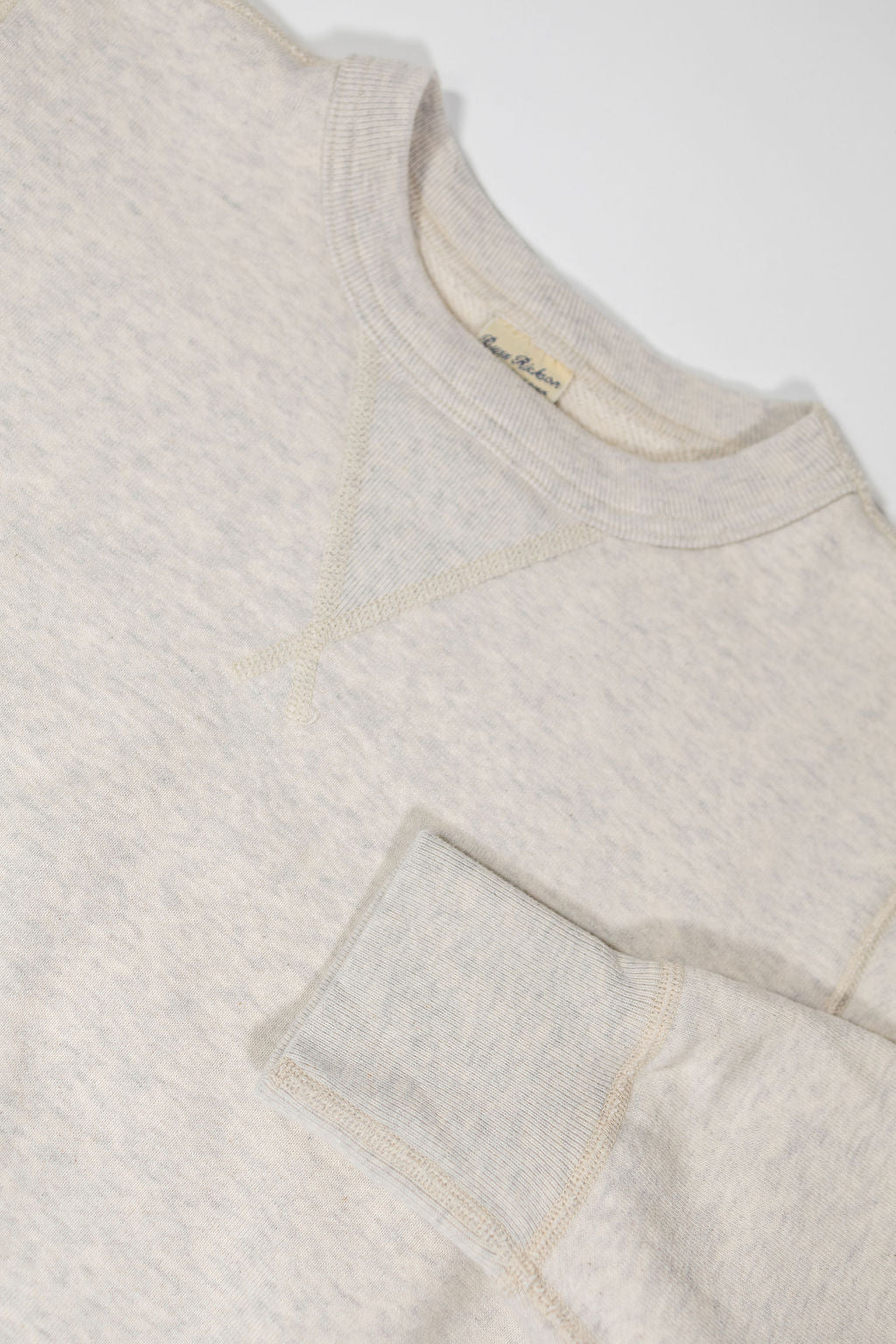 Buzz Rickson's BR65622 Set-in Crew Neck Sweatshirt in Oatmeal - Laying flat, front view close-up with sleeve cuff