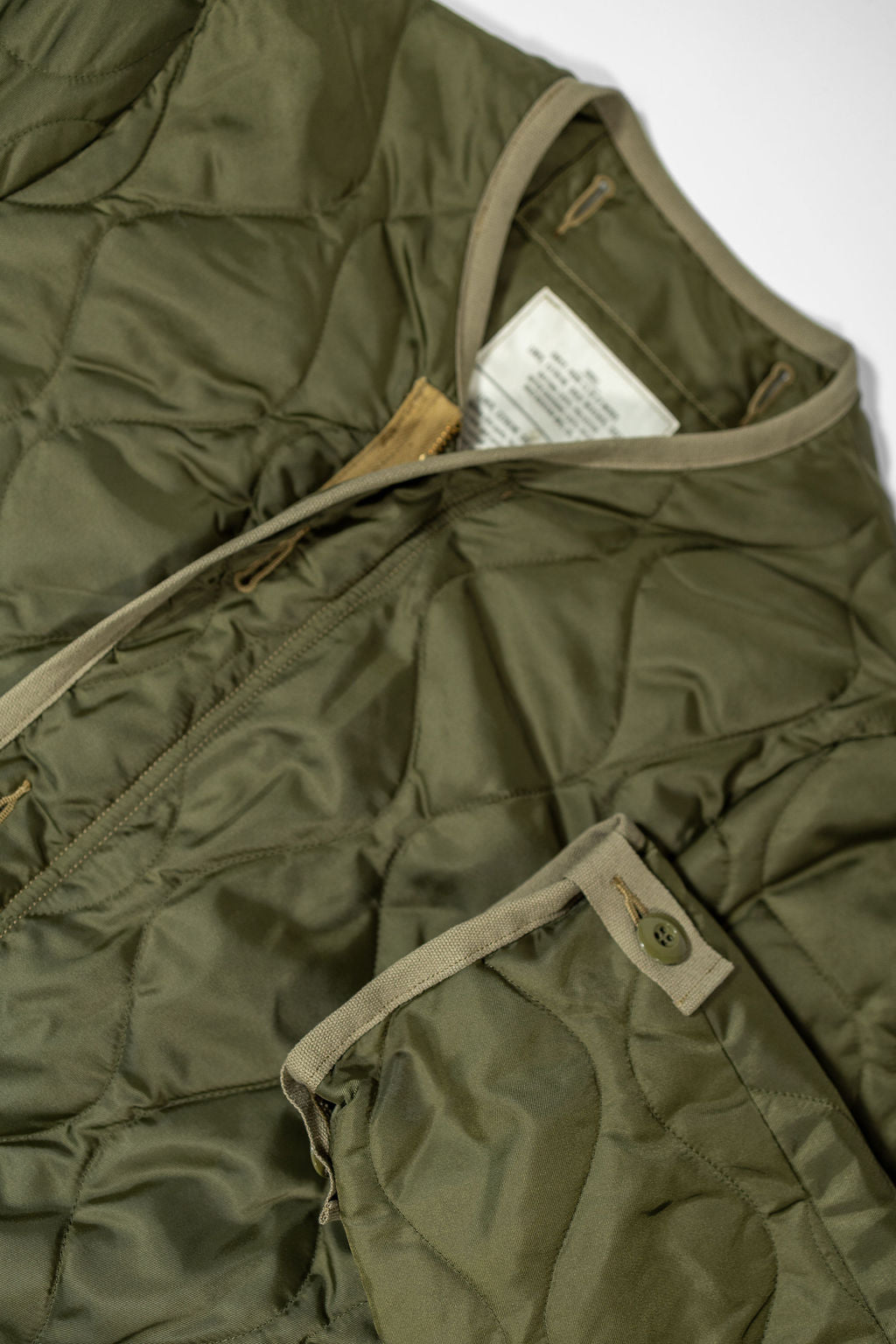 Buzz Rickson's BR15754 Type M-65 Liner in Olive - Laying flat, front close-up with sleeve cuff
