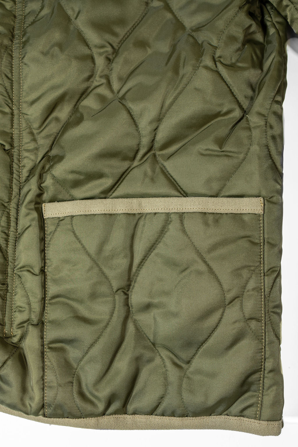 Buzz Rickson's BR15754 Type M-65 Liner in Olive - Laying flat, close-up on pocket