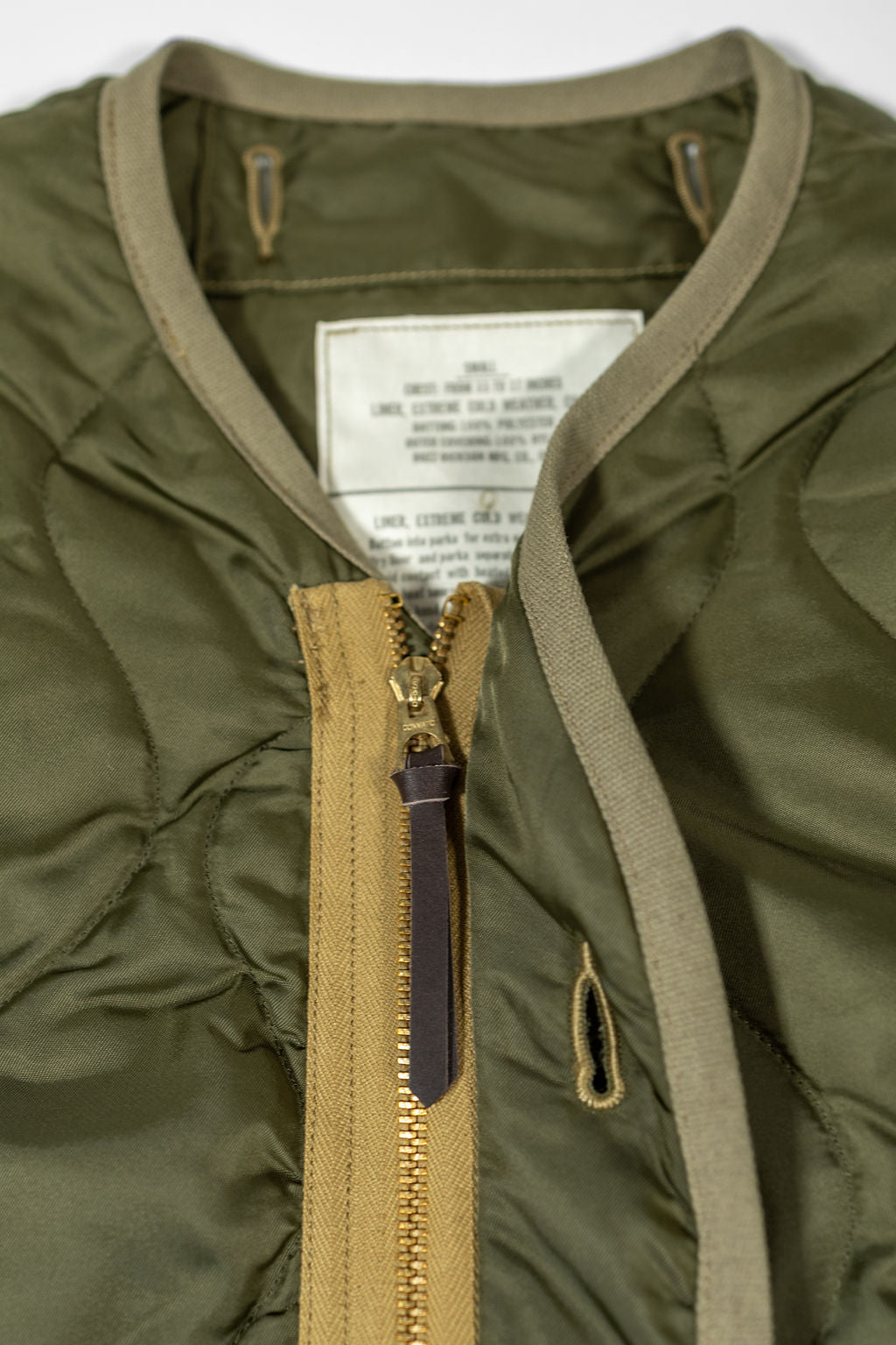 Buzz Rickson's BR15754 Type M-65 Liner in Olive - Laying flat, close-up on zipper