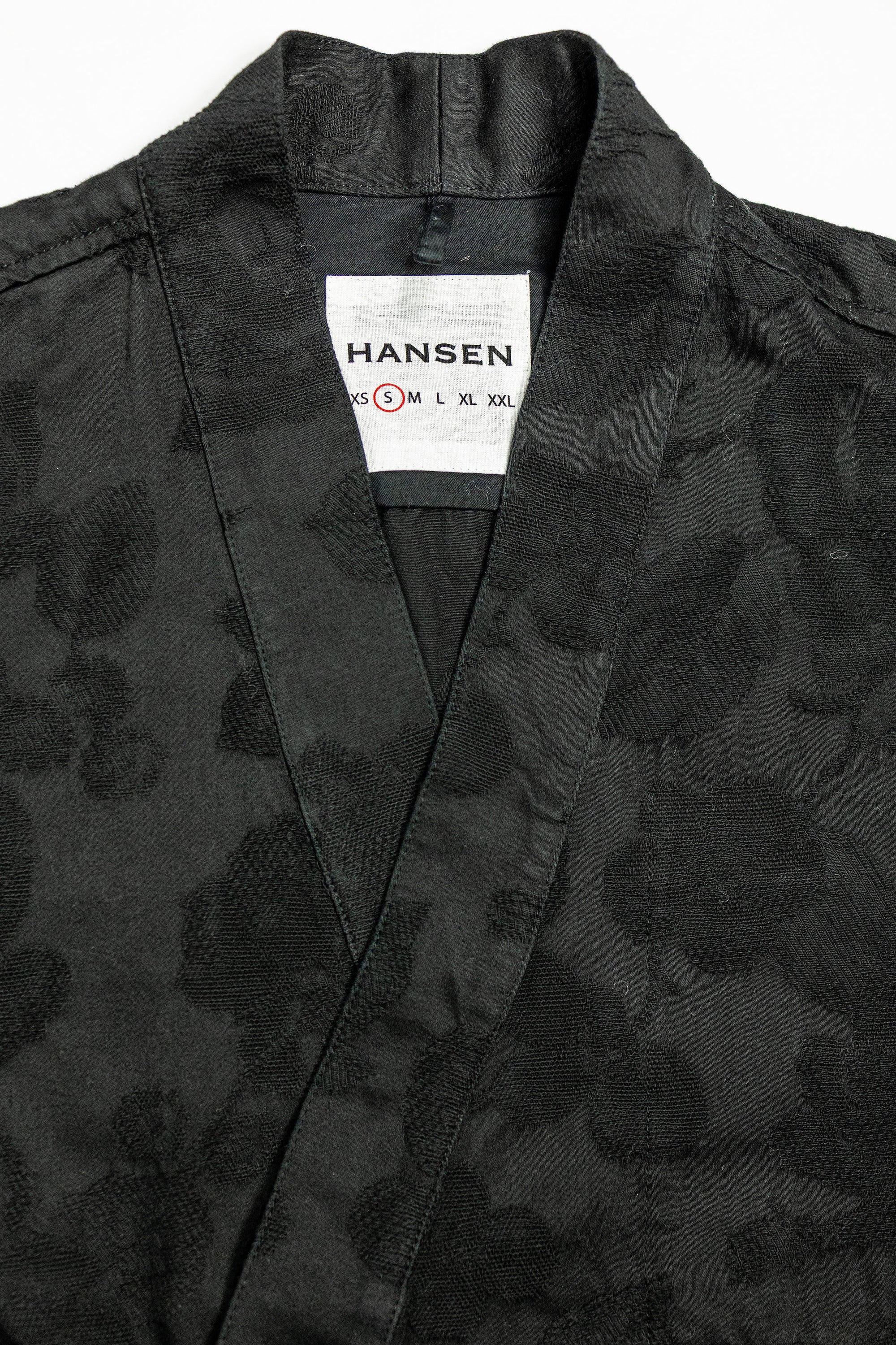 Hansen Garments Roman Loose Cut Jacket - Black Flowers - product shot - front facing - close up -  detail of brand tag and collar - white background