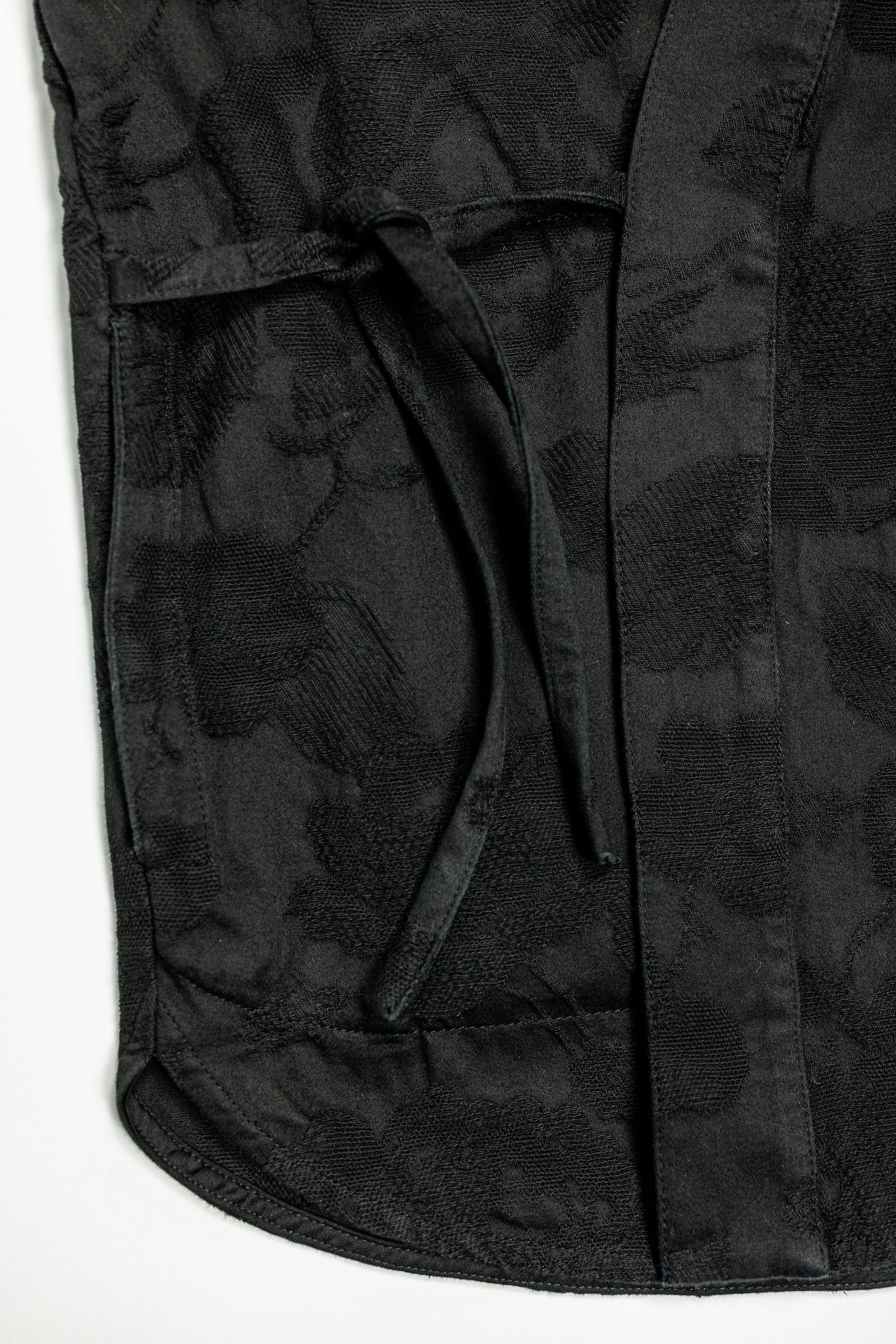 Hansen Garments Roman Loose Cut Jacket - Black Flowers - product shot - front facing - close up -  detail of fabric, bottom of jacket, and tie closure - white background