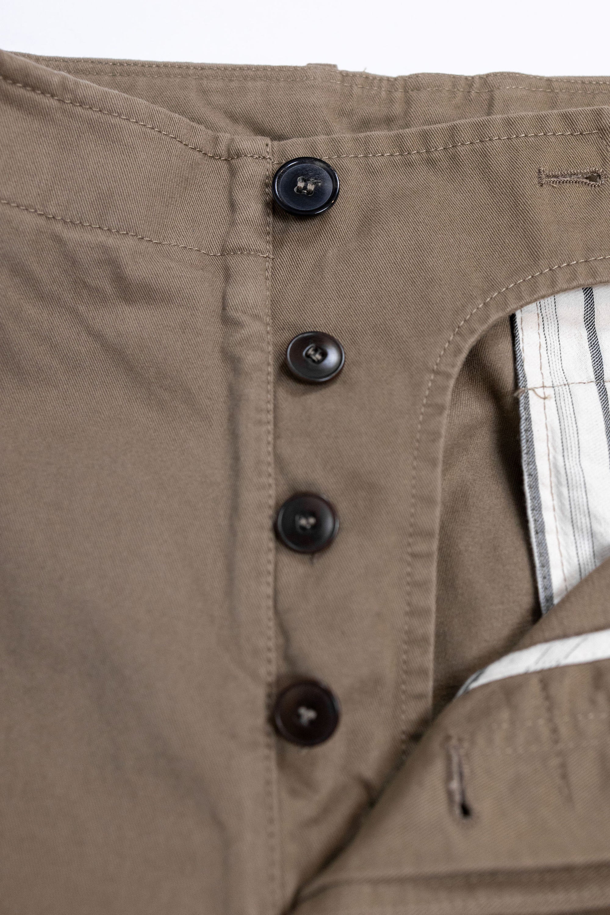 Hansen Garments Bobby Wide Pleated Trousers - Beige - product shot - front facing - white background - pants open - detail of buttons