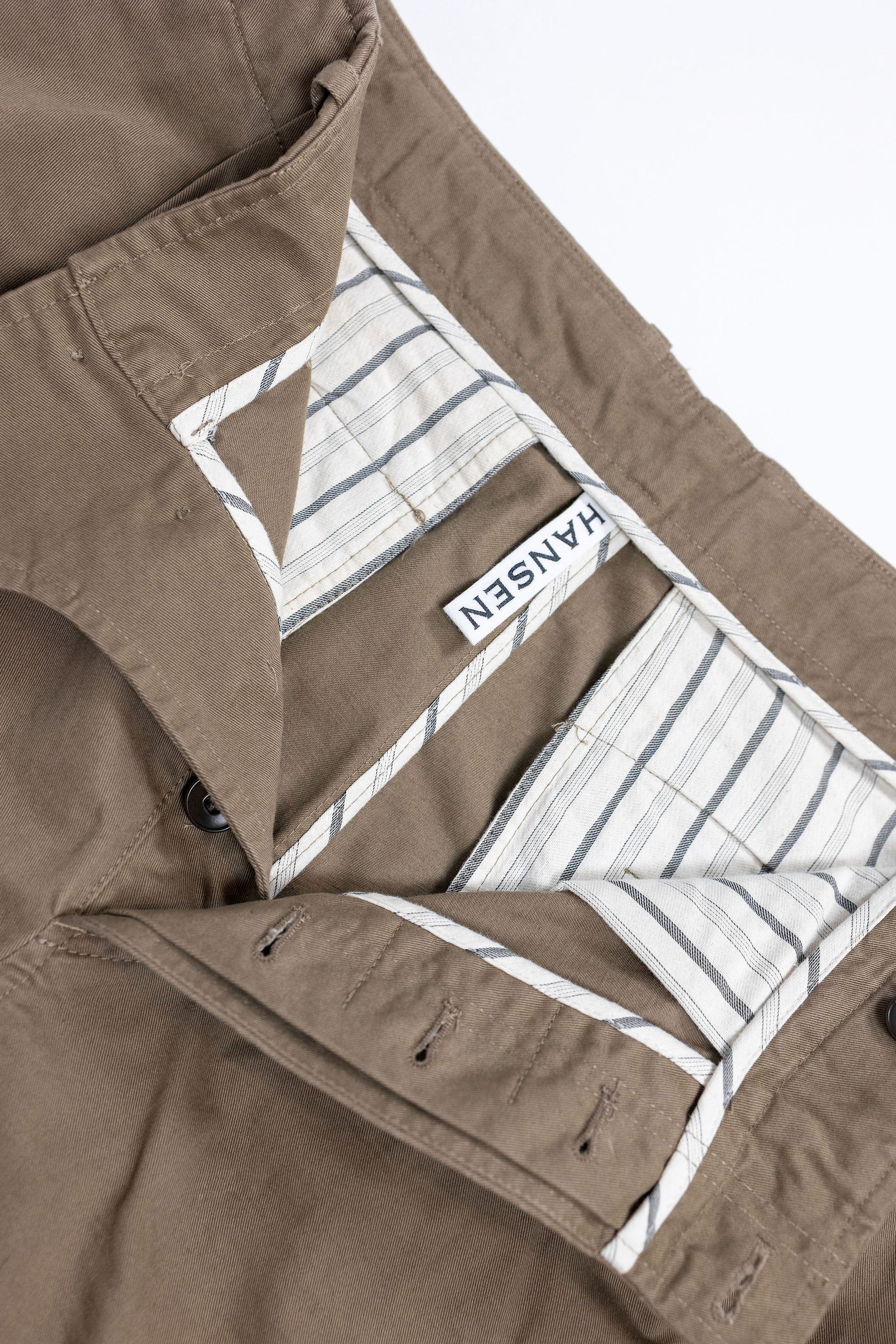 Hansen Garments Bobby Wide Pleated Trousers - Beige - product shot - front facing - white background - pants open - detail of brand tag and interior