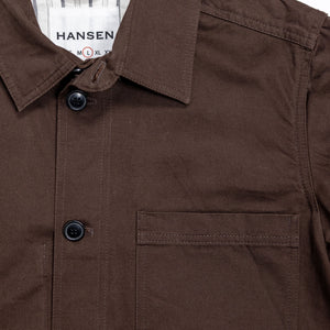 Hansen Garments Bendik Workwear Jacket - Chestnut - product shot - front facing - white background - close up detail of collar, buttons, and pocket