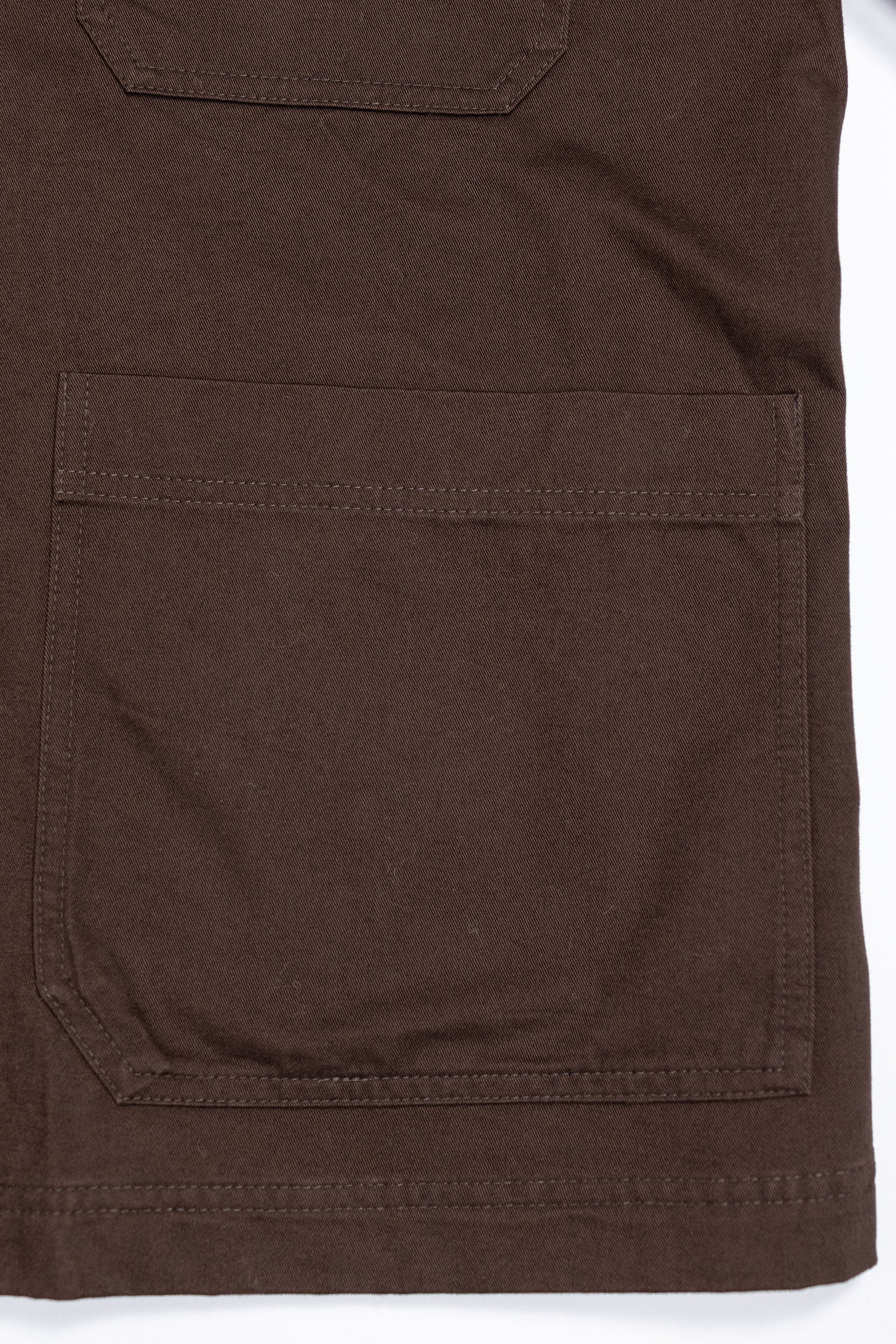 Hansen Garments Bendik Workwear Jacket - Chestnut - product shot - front facing - white background - close up detail of bottom pocket.