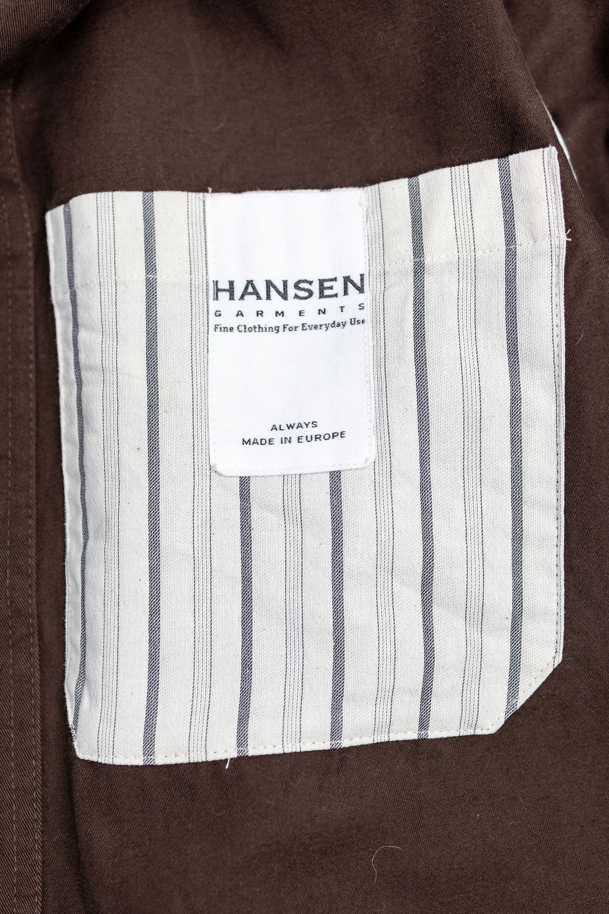 Hansen Garments Bendik Workwear Jacket - Chestnut - product shot - front facing - close up detail of inner jacket brand tag.