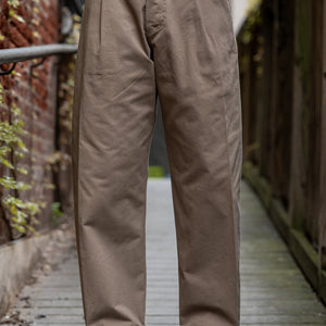 Hansen Garments Bobby Wide Pleated Trousers - Beige - model shot - waist down - front facing - wooden alley background