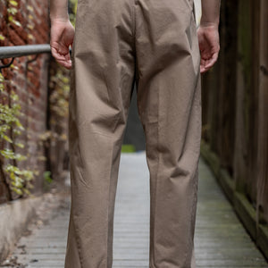 Hansen Garments Bobby Wide Pleated Trousers - Beige - model shot - waist down - back facing - wooden alley background