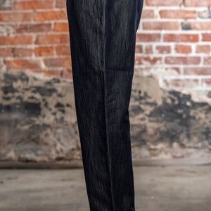 Hansen Garments Emir Loose Drawstring Pants - Navy Dobby - close up - waist down - brick background - side facing