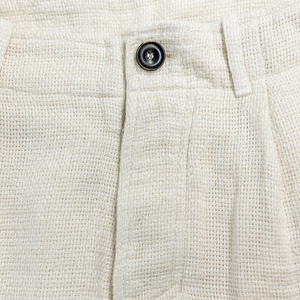Hansen Garments Bobby Wide Pleated Trousers - Off White Gauze - product shot - close up - detail of button and fabric - white background