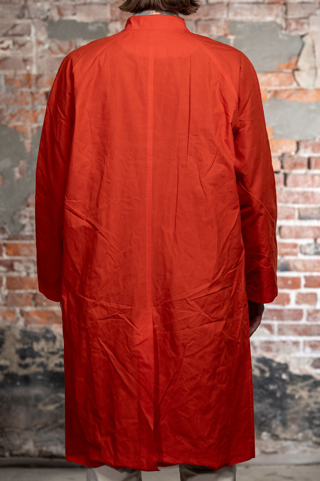 Hansen Garments Morten Long Coat - Waxed Orange on model from the back