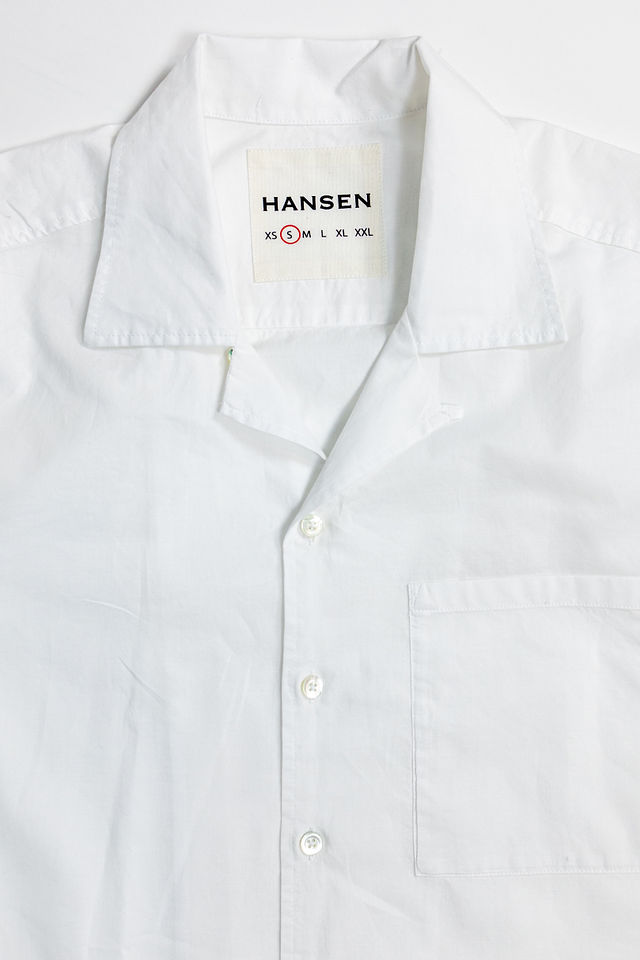 Hansen Garments Caleb Short Sleeve Cabana Shirt - White - product shot - front facing - white backdrop - detail shot of collar, buttons, and brand tag