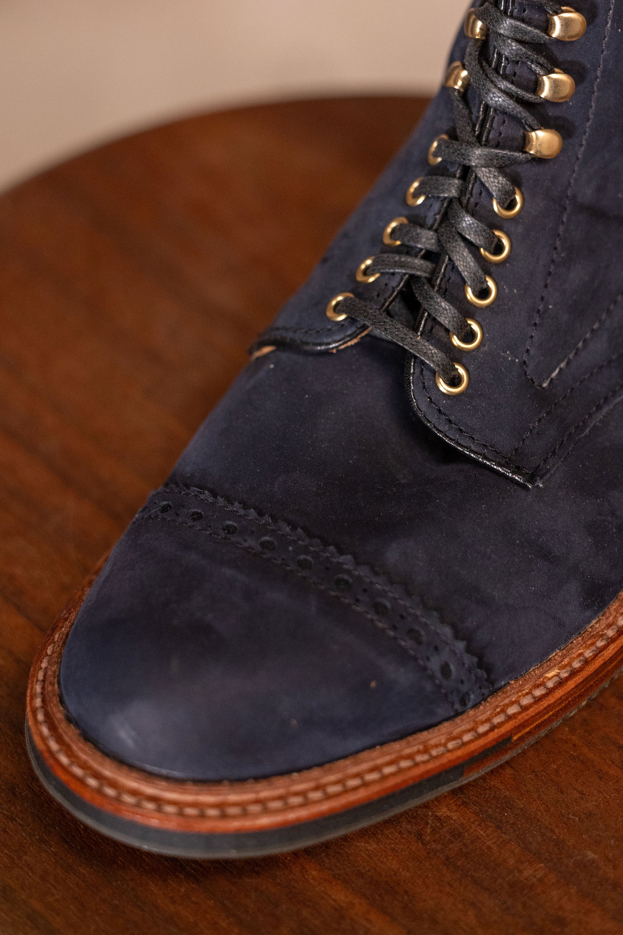 Navy blue suede cap toe boots close up on toe