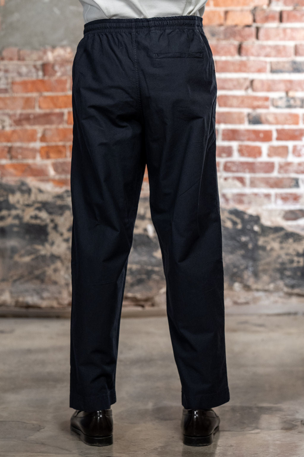 Hansen Garments Jack Casual Drawstring Pants Lava - model shot waist down - brick background - back facing