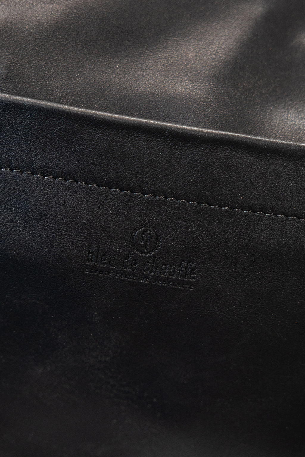 Black duffel bag closeup on embossed bleu de chaeffe logo