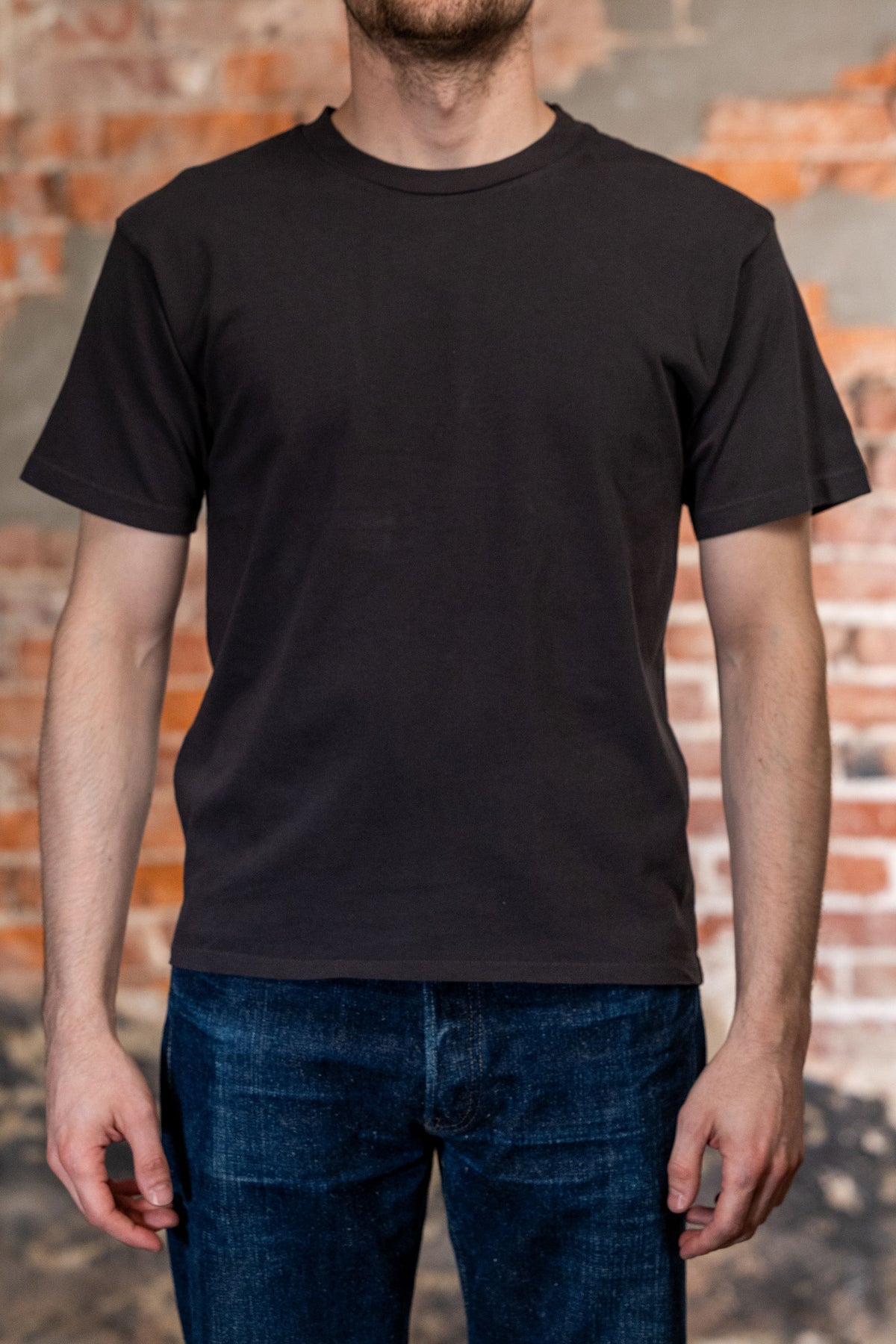 Faded black premium t-shirt front view on model