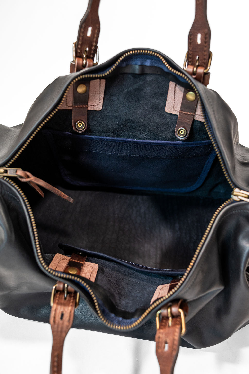 Black duffel bag with brown handles closeup navy pocket