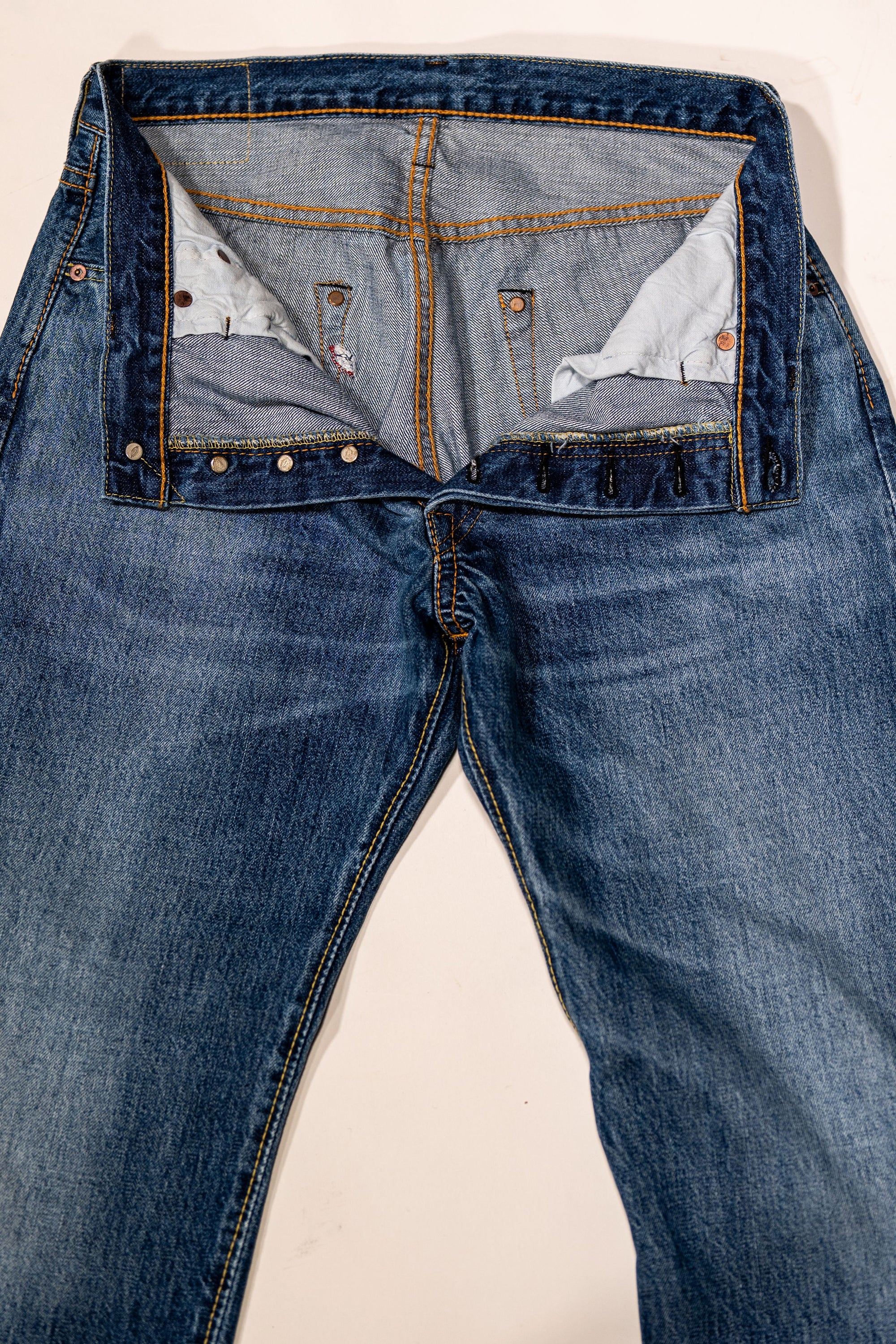 Pure Blue Japan USED-003-ID Regular Straight - 14oz Natural Used Wash Indigo x White. laid on back with buttons undone and opened