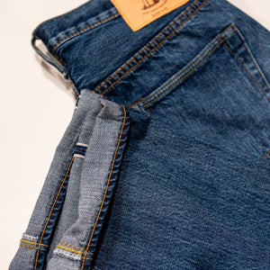 Pure Blue Japan USED-003-ID Regular Straight - 14oz Natural Used Wash Indigo x White. laid on side with close up of cuff detail