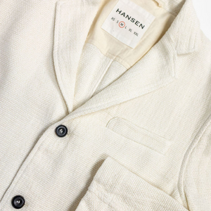 Hansen Garments Charlie Three Button Blazer - Off White Gauze - product shot - close up detail of tag, closed jacket,  and sleeve - white background