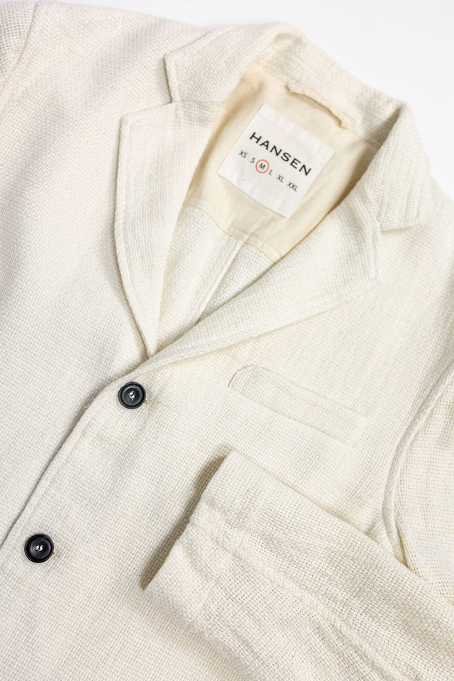 Hansen Garments Charlie Three Button Blazer - Off White Gauze - product shot - close up detail of tag, closed jacket,  and sleeve - white background