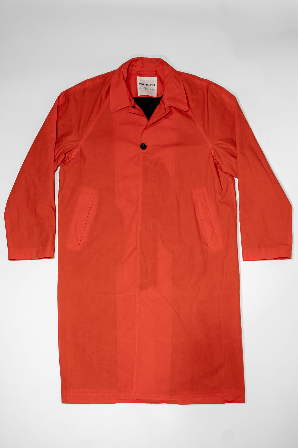 Hansen Garments Morten Long Coat - Waxed Orange laid flat