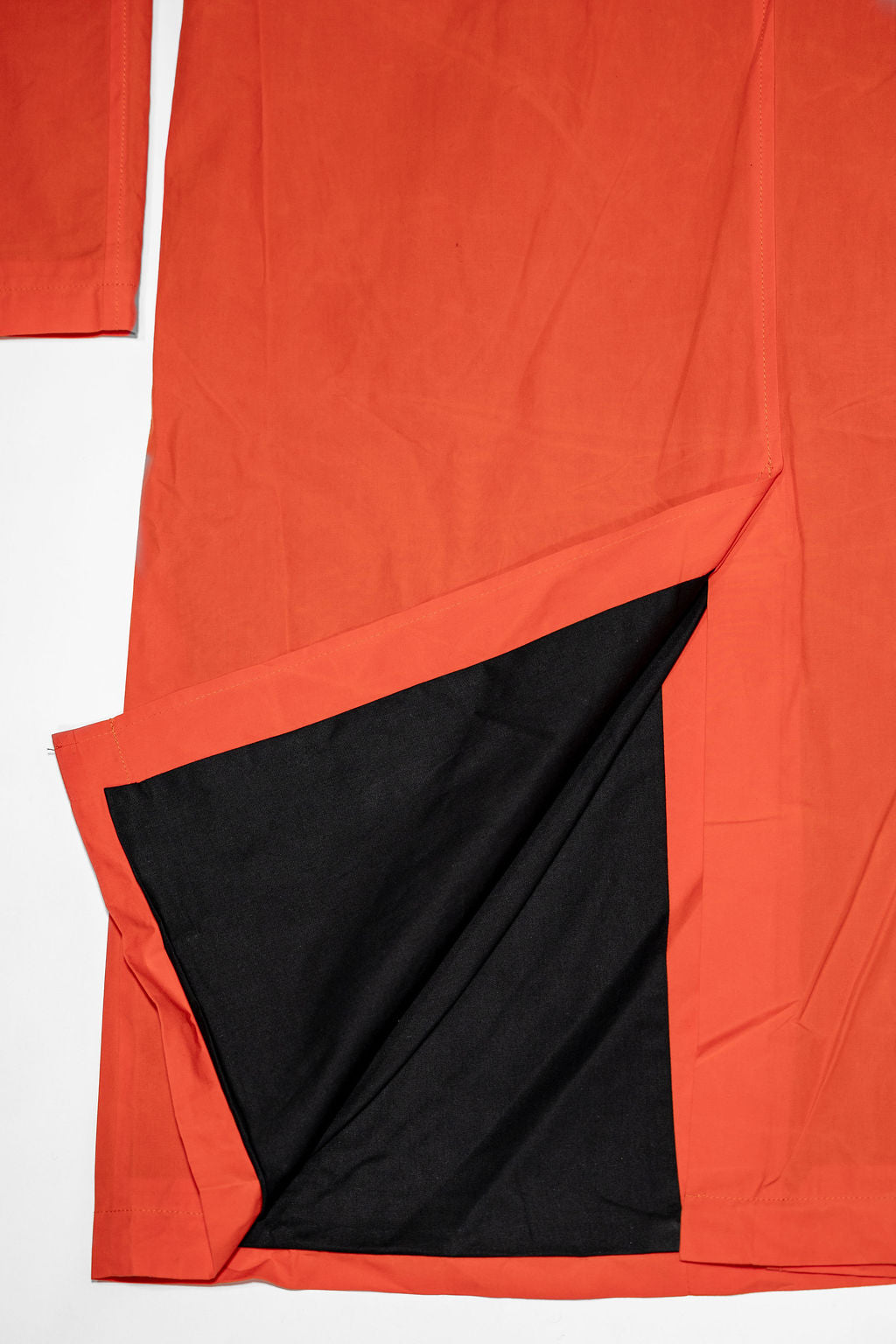 Hansen Garments Morten Long Coat - Waxed Orange laid flat. Details on back slit at bottom of the jacket